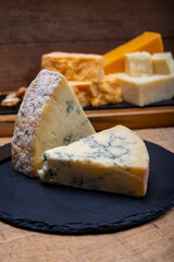 British cheeses collection, blue Stilton, Scottish coloured and English matured cheddar cheeses