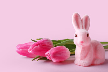 Cute Easter bunny and flowers on pink background