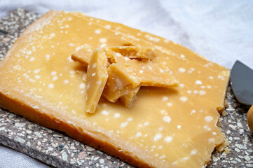 72 months very old Italian parmigiano-reggiano parmesan cheese from Parma has amber color, dry, extremely grainy and crumbly with very intense taste.