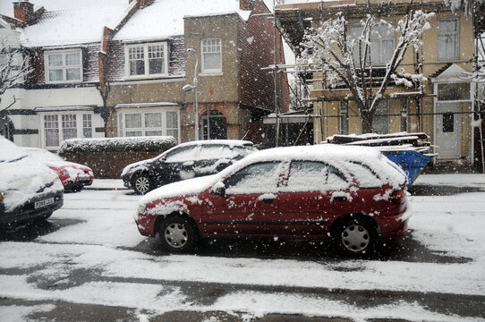 Snow covered cars out in the street, ondon, UK.