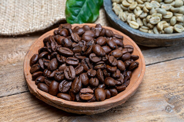 Green un-roasted and brown roasted coffee beans from Africa coffee producing region, cultivating in Ethiopia, Ivory Coast, Uganda, Kenya, Rwanda and Tanzania