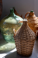 Wine industry of Cyprus island, old wine fermenting glass jugs and bottles for making wine on...