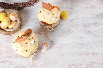 Tasty Easter cakes and painted eggs on light background