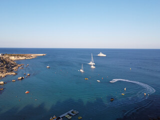 Crystal clear blue water of Mediterranean sea  and yellow rocks in on Konnos beach near Protaras, Cyprus