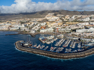 Aerial view on costline with sandy beaches and yachts harbor Puerto Colon on South of Tenerife near Costa Adeje, Canary islands, Spain
