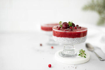 chia seed pudding with berries and mint in a glass jar