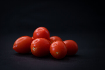 tomatoes on black background