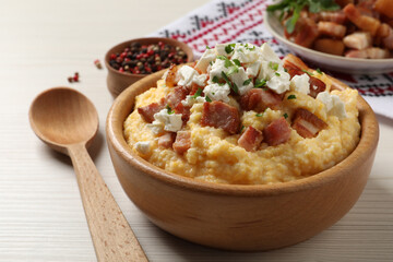 Delicious traditional Ukrainian banosh served on light wooden table