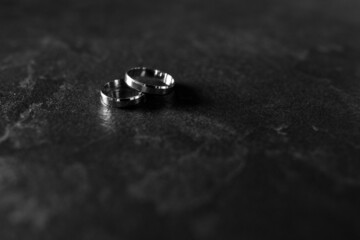 Wedding rings on the table. Wedding details for the ceremony. Wedding accessories. Close-up.
Black and white photo.