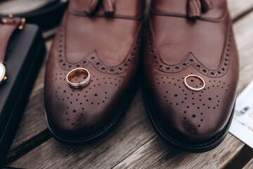 Fototapeta na wymiar Groom's brown wedding shoes. Wedding accessories. Close-up.