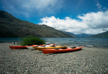 Kayaks on the lake. Stunning view of the coast in nature. Relaxing vacations, travel, adventure exploration.