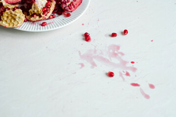 Dirty stains of open pomegranate juice on the table kitchen. daily life dirty stain