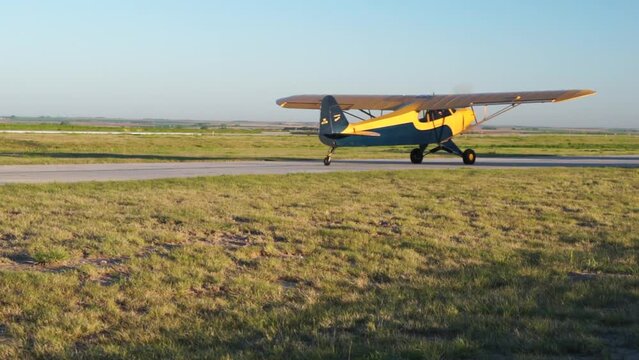 Small high wing aircraft taxis at rural airport