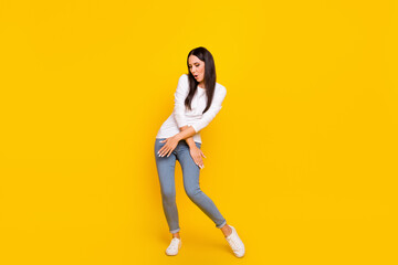 Fototapeta na wymiar Full length photo of young girl good mood dancing dab poser chill isolated over yellow color background