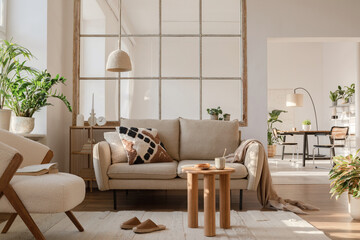 Elegant living room interior design with beige modern sofa, side table and creative accessories....