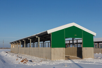 Industrial building of a farm. Hangar. Hangar from sandwich panels. Insulated hangar on a farm.