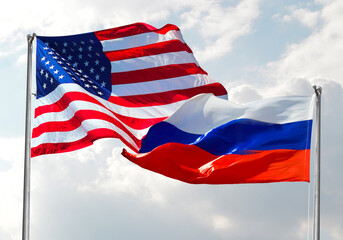 Fototapeta premium Usa Flag on Ussr Russia Flag with clear sky in background