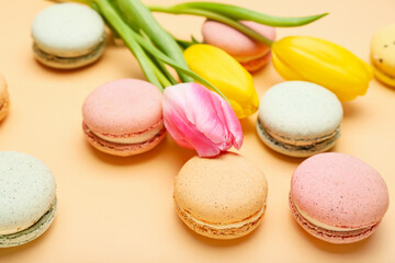Sweet macaroons and beautiful tulip flowers on color background, closeup. International Women's Day celebration