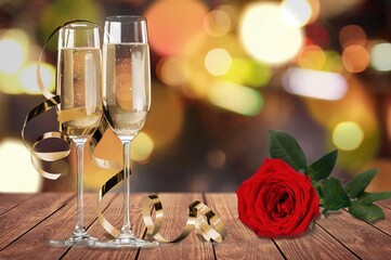 Romantic date setting with champagne glasses and rose. Valentines Day, and date night concept.