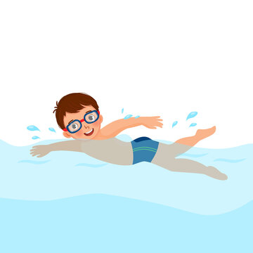 cute little boy wear googles enjoying swimming in a pool