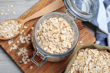 Oatmeal on white wooden table, flat lay