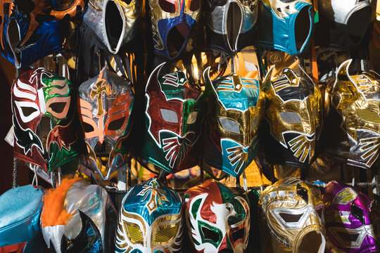 Various colorful wrestling mask hangs from a shop apparel.