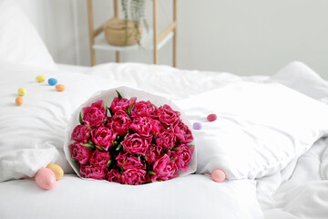 Bouquet of flowers and Easter eggs on soft bed