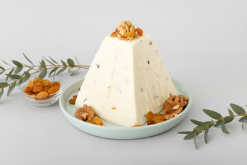 Tasty curd Easter cake with walnuts and raisins on light background