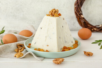 Tasty curd Easter cake with walnuts and raisins on light wooden table
