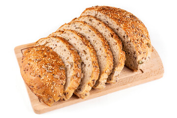Round bread made of whole wheat flour with pumpkin seeds, sesame seeds, flax and sunflower is sliced on a wooden board on a white insulated background. Pattern. Bread without yeast, with sourdough.