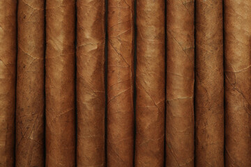 Closeup of many cigars as background, top view