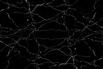 Scattered white crack lines with dust particles on black background