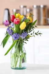 Foto op Canvas Bouquet of blooming flowers in vase on table © Pixel-Shot