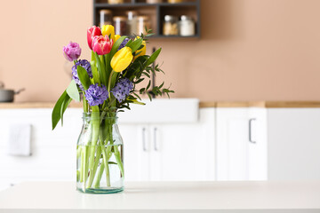 Bouquet of blooming flowers in vase on table