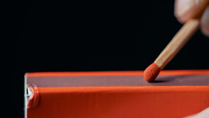 Close Up Shot of a Matchbox and a Match About To Be Lit. Black Background, Macro Photography...
