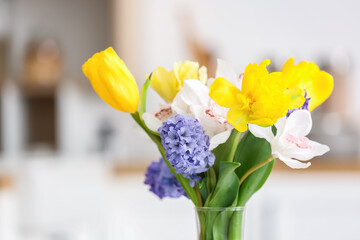 Beautiful flowers in vase against light background, closeup