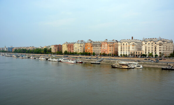 A wide angle shot of colourful apartment buildings along Carl Lutz Rakpart along the River Danube in Budapest, Hungary.
