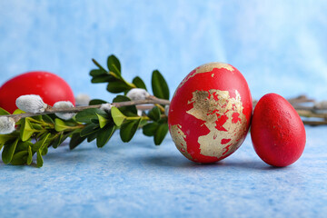 Painted Easter eggs and branches on blue background