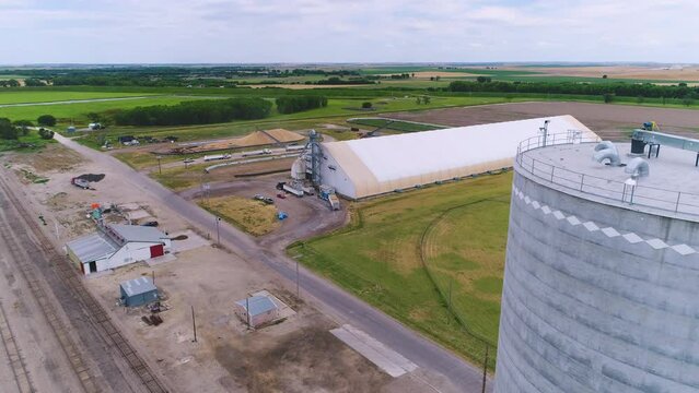 Aerial of trucks delivering to grain storage facility