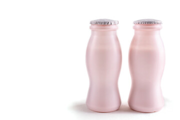 Two bottles of milk yogurt (kefir), on a white isolated background. The concept of probiotics...