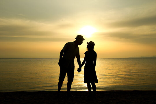 silhouette of a happy loving couple at sunset on the seashore