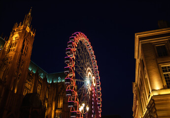 Christmas ferris wheel in front of the cathedral of Metz. Metz, France.