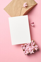 Greeting card mockup with envelope and hyacinth flowers on pink background