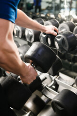 Fototapeta na wymiar Strong male hand hold heavy gym weight
