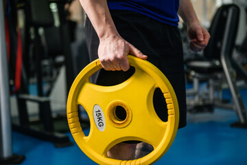 Muscular man hands with gym dumbbell weight