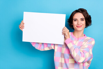 Photo of young pretty woman promoter hold hands paper poster advertising discount isolated over...
