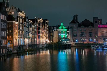 Naklejka premium City scenic from Amsterdam at the Damrak in the Netherlands at night