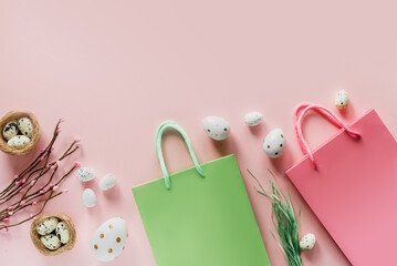 Easter shopping background with green and pink shopping bags with Easter eggs and bird's nest on pink background