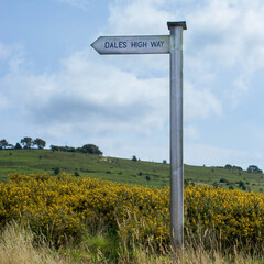 Signpost on Shipley Glen pointing walkers along the popular Dales High Way a 90 mile path from Saltaire in West Yorkshire to Appleby in Cumbria via Ingleborough