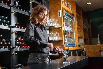 Bartender opening wine bottle